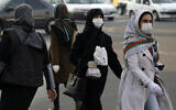 Pedestrians wearing face masks cross a square in western Tehran, Iran, February 29, 2020. Iran is preparing for the possibility of "tens of thousands" of people getting tested for the new coronavirus as the number of confirmed cases spiked again Saturday, Health Ministry spokesman Kianoush Jahanpour said, underscoring the fear both at home and abroad over the outbreak in the Islamic Republic. (AP Photo/Vahid Salemi)