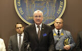 New Jersey Gov. Phil Murphy, center, speaks during a news conference in Ewing, New Jersey, Monday, March 2, 2020. (AP Photo/Seth Wenig)