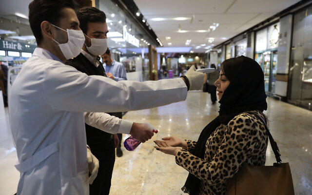 A woman has her temperature checked and her hands disinfected as she enters the Palladium Shopping Center in northern Tehran, Iran, March 3, 2020. (Vahid Salemi/AP) A woman has her temperature checked and her hands disinfected as she enters the Palladium Shopping Center in northern Tehran, Iran, March 3, 2020. (Vahid Salemi/AP)