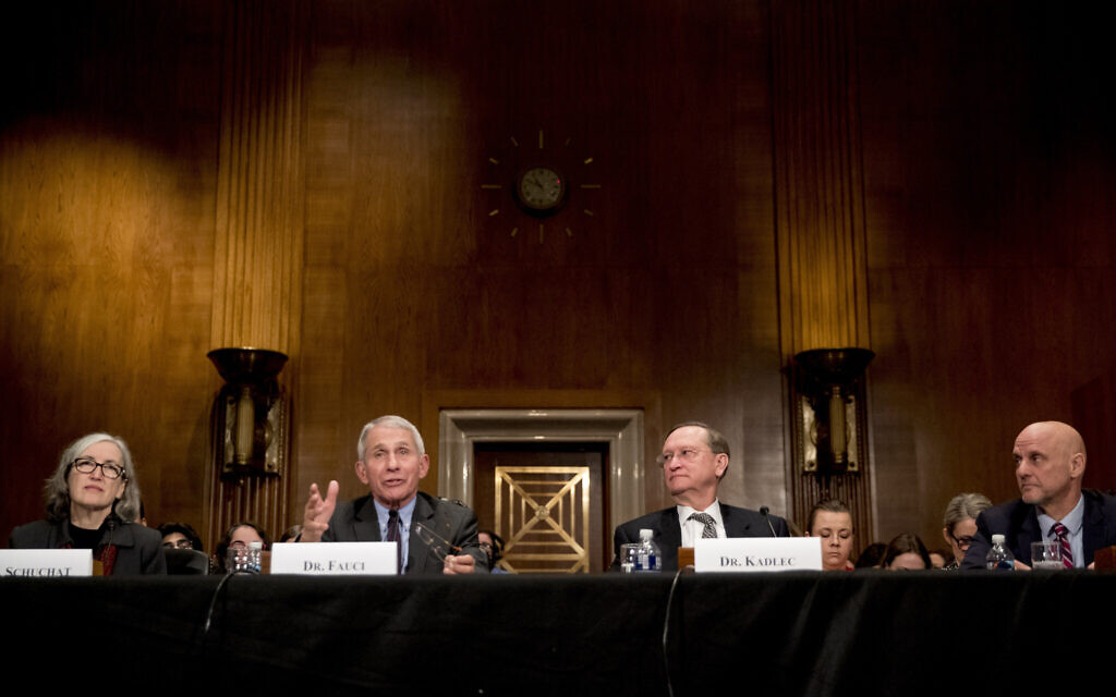 National Institute for Allergy and Infectious Diseases Director Dr. Anthony Fauci, second from left, accompanied by Centers for Disease Control and Prevention Principal Deputy Director Anne Schuchat, left, Health and Human Services Assistant Secretary for Preparedness and Response Dr. Robert Kadlec, second from right, and Food and Drug Administration Commissioner Dr. Stephen Hahn, right, testifies before a Senate Health, Education, Labor and Pensions Committee Hearing on the coronavirus on Capitol Hill, Tuesday, March 3, 2020, in Washington. (AP Photo/Andrew Harnik)
