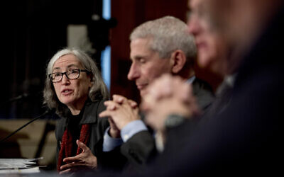 Centers for Disease Control and Prevention Principal Deputy Director Anne Schuchat, center, accompanied by National Institute for Allergy and Infectious Diseases Director Dr. Anthony Fauci, right, testifies before a Senate Health, Education, Labor and Pensions Committee hearing on the coronavirus on Capitol Hill, Tuesday, March 3, 2020, in Washington. (AP Photo/Andrew Harnik)