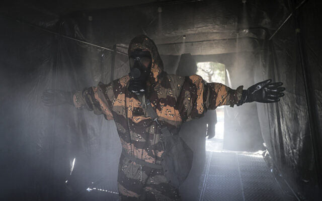 In this photo from March 1, 2020, an Iranian army member disinfects his protective gear against the new coronavirus in Tehran, Iran. (Mahmood Hosseini/Tasnim News Agency via AP) In this photo from March 1, 2020, an Iranian army member disinfects his protective gear against the new coronavirus in Tehran, Iran. (Mahmood Hosseini/Tasnim News Agency via AP)