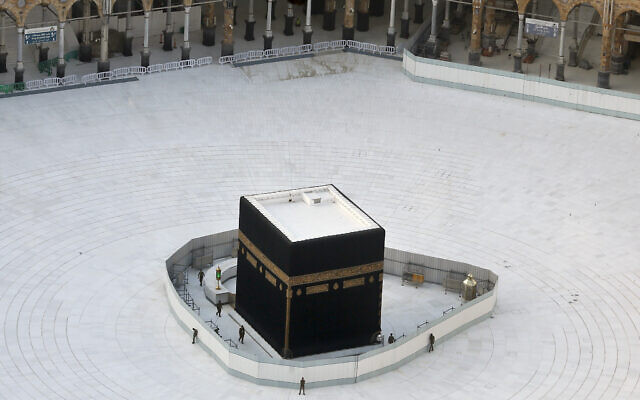 Saudi policemen guard the the Kaaba, the cubic building at the Grand Mosque, in the Muslim holy city of Mecca, Saudi Arabia, Friday, March 6, 2020, amid the coronavirus pandemic (AP Photo/Amr Nabil) Saudi policemen guard the the Kaaba, the cubic building at the Grand Mosque, in the Muslim holy city of Mecca, Saudi Arabia, Friday, March 6, 2020, amid the coronavirus pandemic (AP Photo/Amr Nabil)