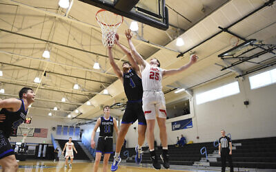 Yeshiva forward Gabriel Leifer (4) and Worcester Polytechnic Institute guard John Wessel (25) battle for rebound during the first half in a first-round game at the men's Division III NCAA college basketball tournament at Johns Hopkins University's Goldfarb Gymnasium, March 6, 2020, in Baltimore. (AP Photo/Terrance Williams)