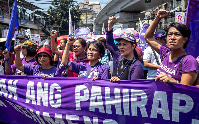 Leaders of various women's groups raise their fists as they march near the Malacanang presidential palace to mark International Women's Day, March 8, 2020, in Manila, Philippines. (AP Photo/Iya Forbes) Leaders of various women's groups raise their fists as they march near the Malacanang presidential palace to mark International Women's Day, March 8, 2020, in Manila, Philippines. (AP Photo/Iya Forbes)