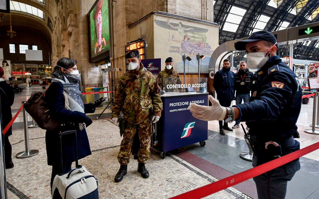 Police officers and soldiers check passengers leaving from Milan main train station, Italy, March 9, 2020 (Claudio Furlan/LaPresse via AP) Police officers and soldiers check passengers leaving from Milan main train station, Italy, March 9, 2020 (Claudio Furlan/LaPresse via AP)