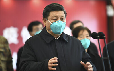 In this photo released by China's Xinhua News Agency, Chinese President Xi Jinping talks by video with patients and medical workers at the Huoshenshan Hospital in Wuhan in central China's Hubei Province, Tuesday, March 10, 2020. (Xie Huanchi/Xinhua via AP)
