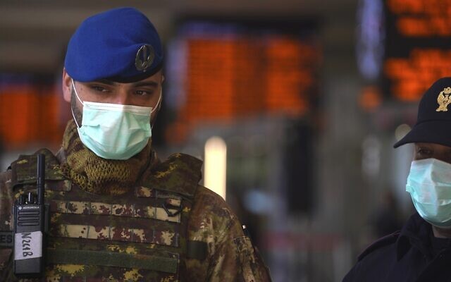 An Italian soldier and border police officer wear masks as they monitor Rome's Termini train station, March 10, 2020, after the government extended a coronavirus containment order previously limited to the country’s north to the rest of the country. (AP Photo/Andrew Medichini) An Italian soldier and border police officer wear masks as they monitor Rome's Termini train station, March 10, 2020, after the government extended a coronavirus containment order previously limited to the country’s north to the rest of the country. (AP Photo/Andrew Medichini)