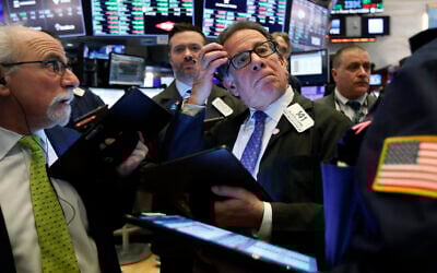 Sal Suarino, center, works with fellow traders on the floor of the New York Stock Exchange on March 10, 2020. (AP/Richard Drew)