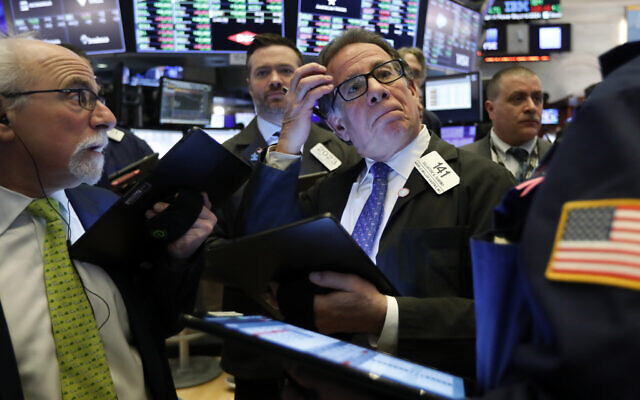 Sal Suarino, center, works with fellow traders on the floor of the New York Stock Exchange on March 10, 2020. (AP/Richard Drew) Sal Suarino, center, works with fellow traders on the floor of the New York Stock Exchange on March 10, 2020. (AP/Richard Drew)