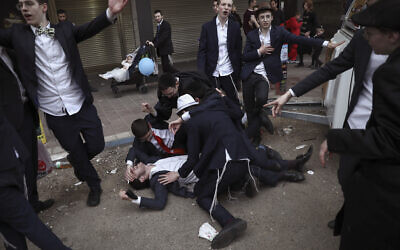 Jewish ultra-Orthodox men celebrate the Jewish festival of Purim in Bnei Brak, Israel, Tuesday, March 10, 2020.. (AP/Oded Balilty)