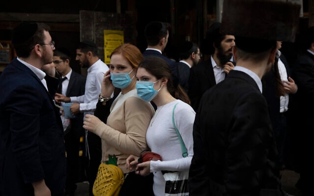 Illustrative: Jewish ultra-Orthodox girls wear face masks during celebrations of the Jewish festival of Purim in Bnei Brak, Israel, March 10, 2020 (AP Photo/Oded Balilty) Illustrative: Jewish ultra-Orthodox girls wear face masks during celebrations of the Jewish festival of Purim in Bnei Brak, Israel, March 10, 2020 (AP Photo/Oded Balilty)