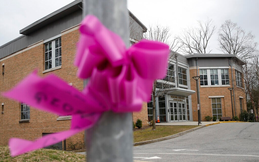 Pink ribbons, displayed for community support, are tied to polls and trees outside the Young Israel synagogue, Tuesday, March 10, 2020, in New York. State officials are shuttering several schools and houses of worship for two weeks in the New York City suburb and sending in the National Guard to help with what appears to be the nation's biggest cluster of coronavirus cases, Gov. Andrew Cuomo said Tuesday. (AP Photo/John Minchillo) Pink ribbons, displayed for community support, are tied to polls and trees outside the Young Israel synagogue, Tuesday, March 10, 2020, in New York. State officials are shuttering several schools and houses of worship for two weeks in the New York City suburb and sending in the National Guard to help with what appears to be the nation's biggest cluster of coronavirus cases, Gov. Andrew Cuomo said Tuesday. (AP Photo/John Minchillo)