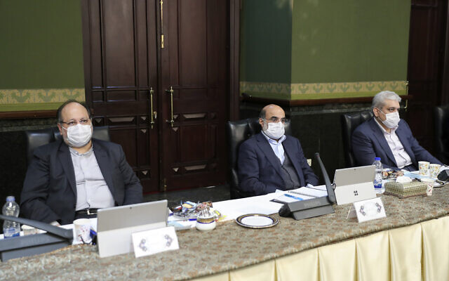 In this photo released by the official website of the office of the Iranian Presidency, cabinet members wearing face masks attend their meeting in Tehran, Iran, Wednesday, March 11, 2020. (Iranian Presidency Office via AP) In this photo released by the official website of the office of the Iranian Presidency, cabinet members wearing face masks attend their meeting in Tehran, Iran, Wednesday, March 11, 2020. (Iranian Presidency Office via AP)