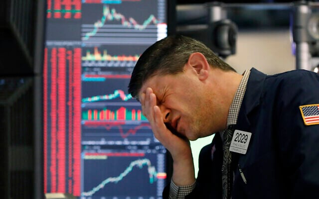 A trader works at his post on the floor of the New York Stock Exchange, March 11, 2020. (AP Photo/Richard Drew)