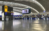 A view of the near empty departure area at London's Heathrow Airport's Terminal 5 departure, March 12, 2020 (Steve Parsons/PA via AP)