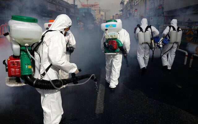 Firefighters disinfect a street against the new coronavirus, in western Tehran, Iran, March 13, 2020. (AP Photo/Vahid Salemi) Firefighters disinfect a street against the new coronavirus, in western Tehran, Iran, March 13, 2020. (AP Photo/Vahid Salemi)