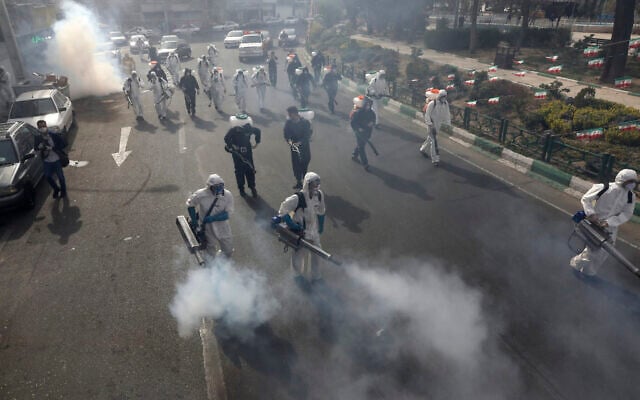 Firefighters disinfect a square against the new coronavirus, in western Tehran, Iran, March 13, 2020 (AP Photo/Vahid Salemi) Firefighters disinfect a square against the new coronavirus, in western Tehran, Iran, March 13, 2020 (AP Photo/Vahid Salemi)