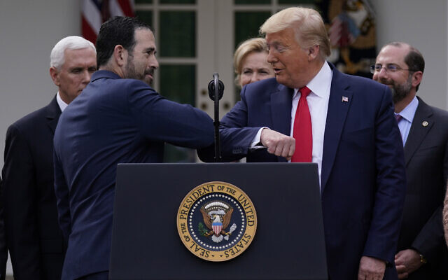 LHC Group’s Bruce Greenstein elbow bumps with US President Donald Trump during a news conference about the coronavirus in the Rose Garden at the White House, March 13, 2020, in Washington. (AP Photo/Evan Vucci) LHC Group’s Bruce Greenstein elbow bumps with US President Donald Trump during a news conference about the coronavirus in the Rose Garden at the White House, March 13, 2020, in Washington. (AP Photo/Evan Vucci)