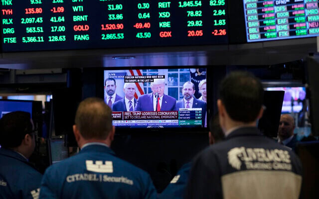 Traders listen at the New York Stock Exchange to US President Donald Trump's televised speech from the White House, March 13, 2020, in New York. (AP Photo/Mark Lennihan) Traders listen at the New York Stock Exchange to US President Donald Trump's televised speech from the White House, March 13, 2020, in New York. (AP Photo/Mark Lennihan)