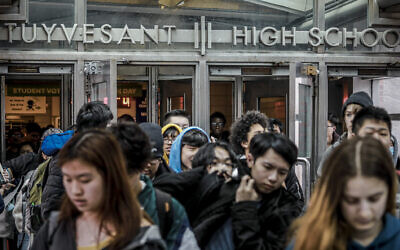 Students at Stuyvesant High School leave after classes end for the week, Friday March 13, 2020, in New York. As concerns continue to grow around the spread of Covid-19, the city's Mayor Bill de Blasio has been reluctant to close the school system because of the consequences for students and families. (AP Photo/Bebeto Matthews)