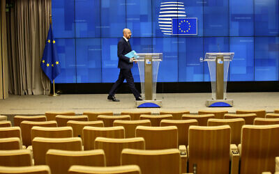 European Council President Charles Michel arrives to address a nearly empty press theater after a videoconference with G7 leaders at the European Council building in Brussels, March 16, 2020. (AP Photo/Olivier Matthys)