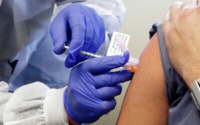 A man receives a shot in the first-stage safety study clinical trial of a potential vaccine for COVID-19, March 16, 2020, at the Kaiser Permanente Washington Health Research Institute in Seattle. (AP Photo/Ted S. Warren) A man receives a shot in the first-stage safety study clinical trial of a potential vaccine for COVID-19, March 16, 2020, at the Kaiser Permanente Washington Health Research Institute in Seattle. (AP Photo/Ted S. Warren)