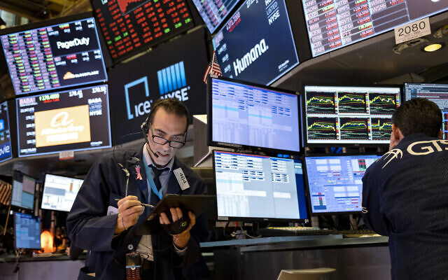 Illustrative: Trader Gregory Rowe works on the floor of the New York Stock Exchange at the end of the trading day, March 16, 2020. (AP/Craig Ruttle) Illustrative: Trader Gregory Rowe works on the floor of the New York Stock Exchange at the end of the trading day, March 16, 2020. (AP/Craig Ruttle)