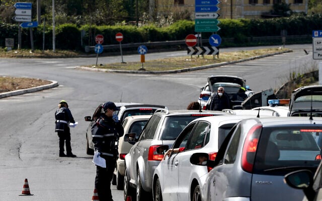 City police check cars in Rome, Saturday, March 21, 2020. Rome’s municipal police have been ordered to stop all cars at roadblocks to make sure the occupants have a valid reason to move about the city under a national lockdown aimed at containing Italy’s surging number of cases of coronavirus infections. The new directive makes clear that the only reasons people should be driving around the city are to go to work or in “situations of necessity,’’ such as health reasons for food shopping. For most people, the new coronavirus causes only mild or moderate symptoms. For some it can cause more severe illness. (Cecilia Fabiano/LaPresse via AP) City police check cars in Rome, Saturday, March 21, 2020. Rome’s municipal police have been ordered to stop all cars at roadblocks to make sure the occupants have a valid reason to move about the city under a national lockdown aimed at containing Italy’s surging number of cases of coronavirus infections. The new directive makes clear that the only reasons people should be driving around the city are to go to work or in “situations of necessity,’’ such as health reasons for food shopping. For most people, the new coronavirus causes only mild or moderate symptoms. For some it can cause more severe illness. (Cecilia Fabiano/LaPresse via AP)
