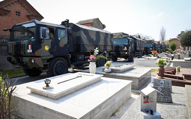 A convoy of Italian Army trucks arrives from Bergamo carrying bodies of coronavirus victims to the cemetery of Ferrara, Italy, where they will be cremated, Saturday, March 21, 2020. (Massimo Paolone/LaPresse via AP) A convoy of Italian Army trucks arrives from Bergamo carrying bodies of coronavirus victims to the cemetery of Ferrara, Italy, where they will be cremated, Saturday, March 21, 2020. (Massimo Paolone/LaPresse via AP)
