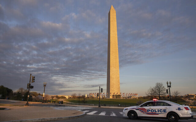 A District of Columbia Police Car blocks the road near the Washington Monument in an effort to discourage crowds from visiting the cherry blossom trees in full bloom, Sunday, March 22, 2020, in Washington. Sections of the National Mall and tidal basin areas have been closed to vehicular traffic to encourage people to practice social distancing and not visit Washington's iconic cherry blossoms this year due to coronavirus concerns. The trees are in full bloom this week and would traditionally draw a large crowd. (AP Photo/Jacquelyn Martin) A District of Columbia Police Car blocks the road near the Washington Monument in an effort to discourage crowds from visiting the cherry blossom trees in full bloom, Sunday, March 22, 2020, in Washington. Sections of the National Mall and tidal basin areas have been closed to vehicular traffic to encourage people to practice social distancing and not visit Washington's iconic cherry blossoms this year due to coronavirus concerns. The trees are in full bloom this week and would traditionally draw a large crowd. (AP Photo/Jacquelyn Martin)