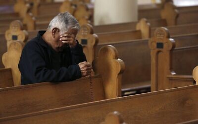 A parishioner wipes away tears during a modest and shortened service due to the coronavirus, at St. Mary's Roman Catholic Basilica in Phoenix, Arizona, March 22, 2020. (Ross D. Franklin/AP)