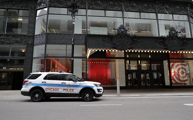 A police car parked in front of a Target store in downtown Chicago, March 22, 2020. (Nam Y. Huh/AP)