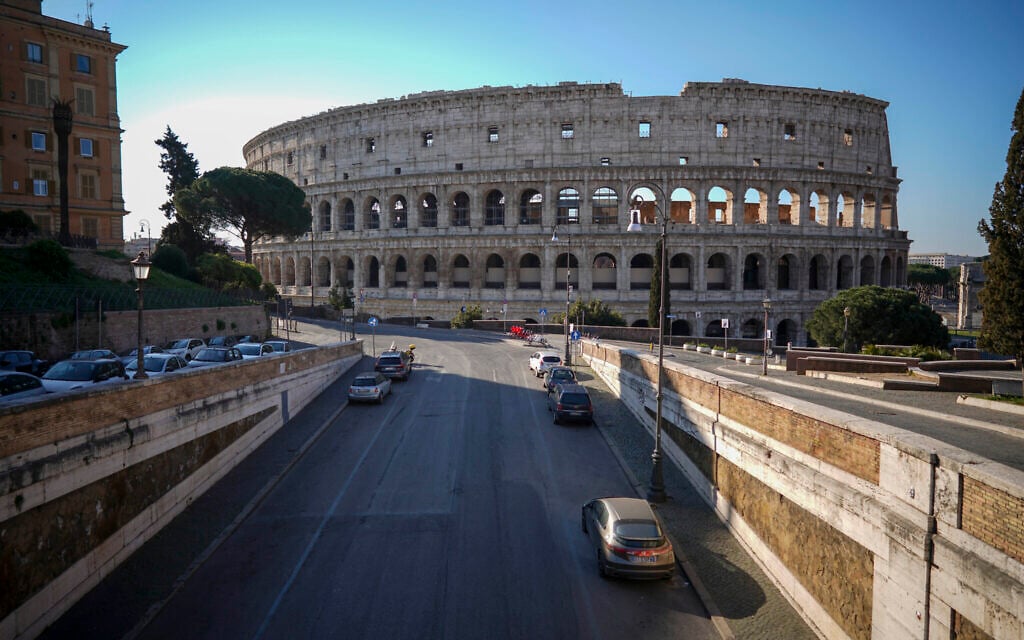 An empty street leads to the ancient Colosseum, in Rome, Tuesday, March 24, 2020. (AP Photo/Andrew Medichini)