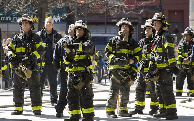 Illustrative: Firefighters watch as colleagues work on a minor fire in an elevated subway station, Tuesday, March 24, 2020 in New York. Mayor Bill de Blasio says police will be step in to enforce social distancing. (AP Photo/Mark Lennihan) Illustrative: Firefighters watch as colleagues work on a minor fire in an elevated subway station, Tuesday, March 24, 2020 in New York. Mayor Bill de Blasio says police will be step in to enforce social distancing. (AP Photo/Mark Lennihan)