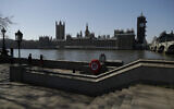 A general view of the Houses of Parliament seen from the south bank of the River Thanes in London, Wednesday, March 25, 2020. (AP Photo/Matt Dunham)