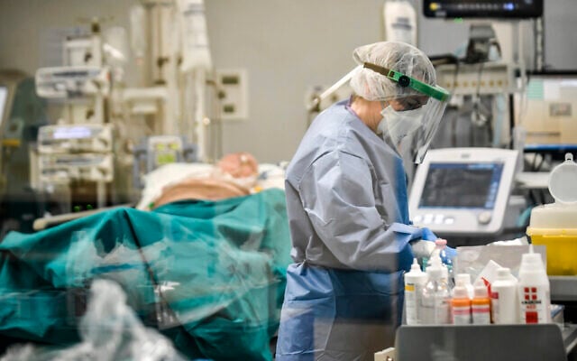 In this photograph taken from behind a window, doctors work on COVID-19 patients in the intensive care unit of San Matteo Hospital, in Pavia, northern Italy, March 26, 2020. (Claudio Furlan/LaPresse via AP) In this photograph taken from behind a window, doctors work on COVID-19 patients in the intensive care unit of San Matteo Hospital, in Pavia, northern Italy, March 26, 2020. (Claudio Furlan/LaPresse via AP)