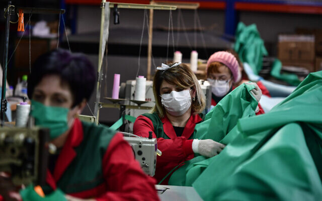 Volunteer workers in a clothing factory manufacturing firefighting gear, make hospital gowns for medical staff to protect them from the coronavirus, in Arnedo, northern Spain, March 30, 2020. (AP Photo/Alvaro Barrientos) Volunteer workers in a clothing factory manufacturing firefighting gear, make hospital gowns for medical staff to protect them from the coronavirus, in Arnedo, northern Spain, March 30, 2020. (AP Photo/Alvaro Barrientos)