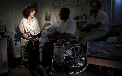 Illustrative: In this photo taken Thursday, June 20, 2013, Israeli Rabbi Miriam Berkowitz, left, of the Kashuvot organization for pastoral care, posed for a photo with a patient and nurse  at a hospital in Jerusalem. (AP Photo/Sebastian Scheiner)
