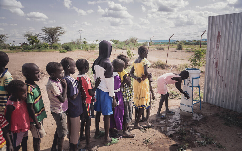 Children using the safe water facility at IsraAID space in Kakuma Refugee Camp, Kenya. (Lior Sperandeo/IsraAID)