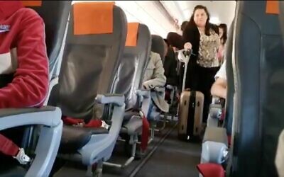 Screen capture from video of a passenger leaving a flight from Tel Aviv to Berlin after the Health Ministry broadened self-quarantine demands for travelers, March 4, 2010. (Twitter)