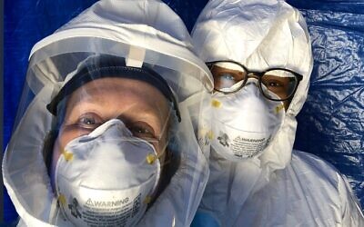 Dr. Judy Melinek (left) and colleague in their PPEs, including PAPR for Melinek. (Twitter)