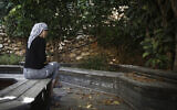 Illustrative photo: An Orthodox Jewish woman sits in the garden of the abused women's shelter in Beit Shemesh, July 15, 2014. (Hadas Parush/Flash90)