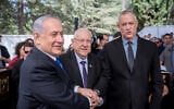 President Reuven Rivlin, center, Prime Minister Benjamin Netanyahu, left, and Blue and White leader Benny Gantz shake hands at the memorial ceremony for the late president Shimon Peres at the Mount Herzl cemetery in Jerusalem on September 19, 2019. (Yonatan Sindel/Flash90)