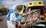 A Magen David Adom paramedic wearing protective gear as a preventive measure against the coronavirus, outside a special emergency call center in Kiryat Ono, February 26, 2020. (Flash90)
