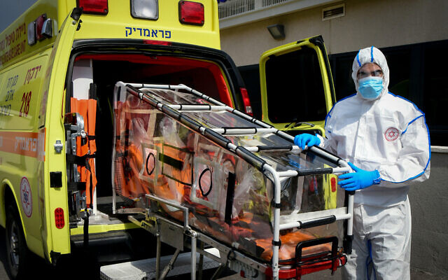 Magen David Adom worker wears protective clothing as a preventive measure against the coronavirus seen outside the special emergency Call Center in Kiryat Ono on February 26, 2020. (Flash90) Magen David Adom worker wears protective clothing as a preventive measure against the coronavirus seen outside the special emergency Call Center in Kiryat Ono on February 26, 2020. (Flash90)