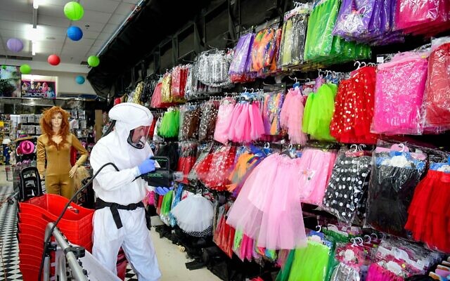 Workers disinfect a shop in Or Yehuda, after a man who works at the shop and returned from Italy tested positive for coronavirus, February 28, 2020 (Flash90) Workers disinfect a shop in Or Yehuda, after a man who works at the shop and returned from Italy tested positive for coronavirus, February 28, 2020 (Flash90)