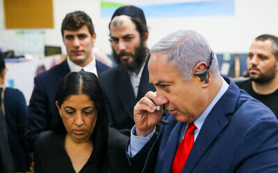 Prime Minister Benjamin Netanyahu visits at Ministry of Health Call Center in Kiryat Malachi on March 1, 2020. (Flash90)