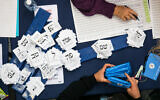 Officials count vote ballots from the elections at the Knesset in Jerusalem, March 4, 2020. (Olivier Fitoussi/Flash90)