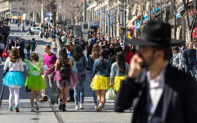 Israeli teenagers dressed up in costumes ahead of the Jewish holiday of Purim walk in the city center of Jerusalem on March 8, 2020. (Olivier Fitoussi/Flash90) Israeli teenagers dressed up in costumes ahead of the Jewish holiday of Purim walk in the city center of Jerusalem on March 8, 2020. (Olivier Fitoussi/Flash90)